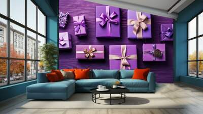 Top view of gifts, bows and Christmas decorations on a vivid purple wooden background Wall mural