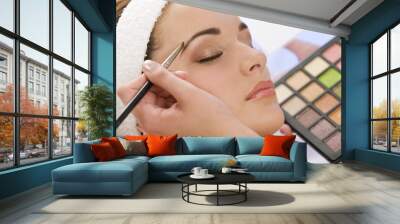 beautiful woman having make up applied by beautician at spa Wall mural