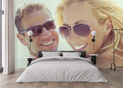 Happy Attractive Woman and Man Couple In Sunglasses At Beach Wall mural