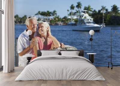 happy senior couple by river or sea with boat Wall mural