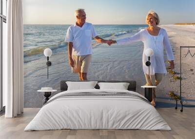 happy senior couple walking holding hands tropical beach Wall mural