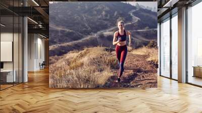 Beautiful Caucasian White Woman Runs on a Trail in the Morning Sunlight Wall mural