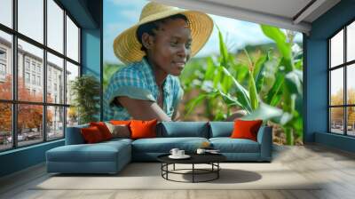 African woman farmer inspecting maize crop in field. Wall mural