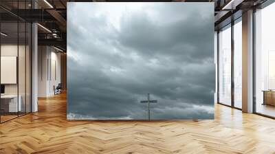 Christian cross symbolizes Jesuss resurrection on cloudy sky background. Wall mural