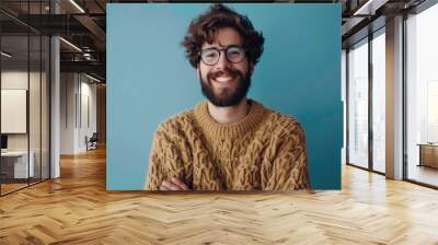 Confident young man in casual attire smiling at camera. Wall mural