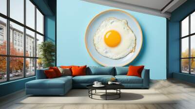 Delicious breakfast with fried egg on blue plate Wall mural