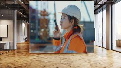 Female construction engineer on site  talking on phone. Wall mural