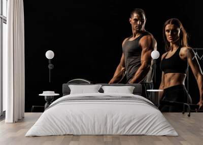 Fit couple at gym promoting healthy lifestyle for sports advertising. Wall mural