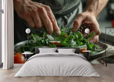 Male cook adding greens to finish dish in close up. Wall mural