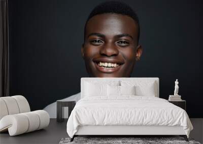 Portrait of happy young African American man on black background. Wall mural