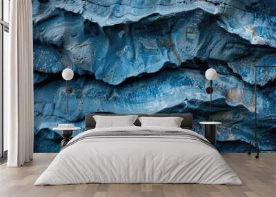 Sea and wind erosion shapes blue rock with smooth lines. Wall mural