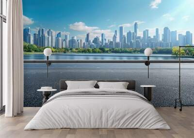 Side view of asphalt road highway with lake garden and modern city skyline in background. Wall mural