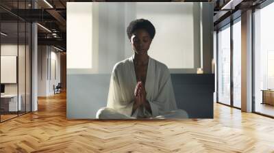 Black woman praying or meditating Wall mural