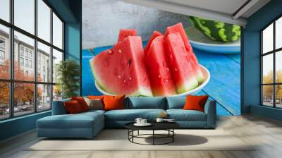 fresh juicy sliced watermelon on plate on blue wooden table summer fruit Wall mural