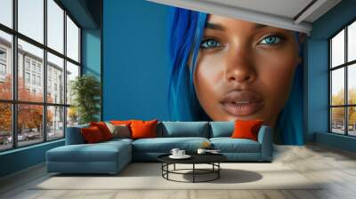 African American woman with vibrant blue hair set against a blue backgroun Wall mural