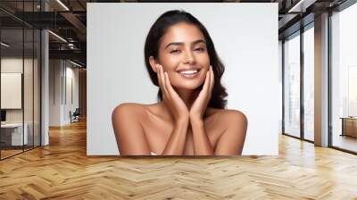 Beautiful happy young Indian woman touching her face caring for facial skin. Skincare concept Wall mural