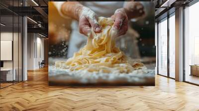 Close up view of hands making fresh italian pasta on wooden kitchen table Wall mural