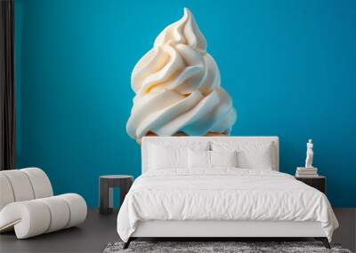 Delicious creamy white vanilla ice cream cone on a blue background Wall mural