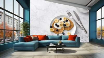 Plate of homemade breakfast with forest fruits and cup of coffee at marble table. Wall mural