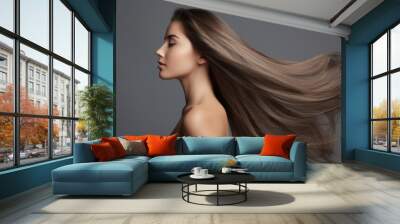 Profile portrait of a beautiful brunette woman with long straight hair on a dark gray background Wall mural