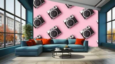 Seamless pattern with vintage instant camera at pastel pink background. Wall mural