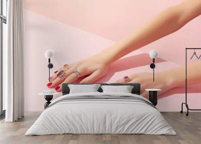 Womans hand with rinds on pink background Wall mural