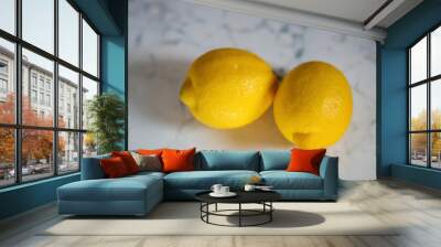 Lemon. Two fresh ripe lemons isolated on a marble table Wall mural