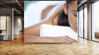 Beautiful woman is resting on spa bed Wall mural