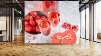 Bottle of rose champagne, glasses with fresh strawberries and heart shaped gift Wall mural