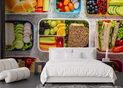 Shot of school lunchboxes with various healthy nutritious meals on stone background Wall mural