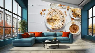 Whole delicious apple cake with almonds served on wooden table Wall mural