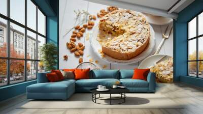 Whole delicious apple cake with almonds served on wooden table Wall mural