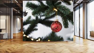 Christmas tree branches with red ball ornament on magic festive background with blurred lights. Xmas celebration concept. Beautiful Holiday Card with copy space Wall mural