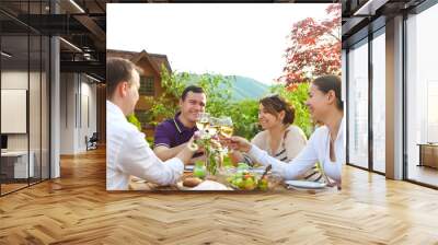 Group of happy friends toasting wine glasses in the garden Wall mural