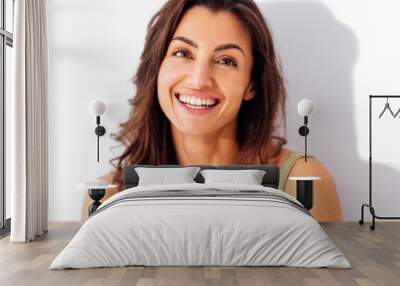 Portrait of happy young beautiful smiling woman. Studio shot of pretty caucasian brunette female on a white background. Wall mural