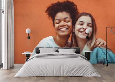 Portrait of two happy joyful teen girls of different races making selfie, enjoying friendship. Wall mural