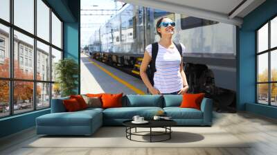 Young woman on train station. Wall mural