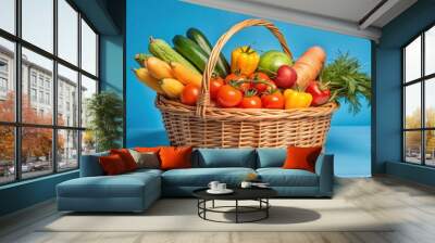 basket filled with freshly harvested vegetables like tomatoes, cucumbers, and carrots Wall mural