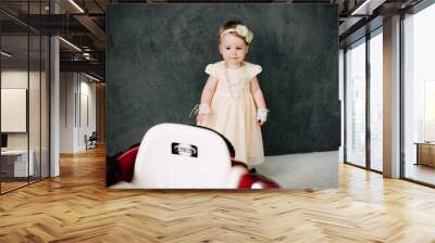 two babies wedding - girl dressed as bride playing with toy car Wall mural