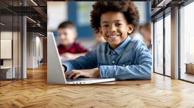 Joyful young African American boy immersed in technology with a bright smile while using his laptop Wall mural