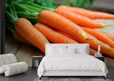 Freshly picked carrots resting on a wooden cutting board Wall mural