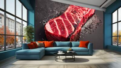 Juicy bloody steak on a burning black surface. Shallow depth of field Wall mural