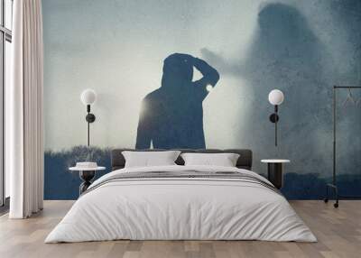 A moody lone hooded figure, back to camera, looking at a giant ghostly figure of a female floating in the sky. With an abstract, grunge, edit. Wall mural