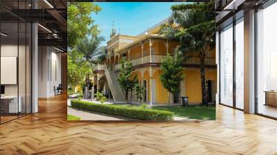 Explore the vibrant architecture of a historic building in Luanda Angola surrounded by lush greenery and a clear blue sky Wall mural