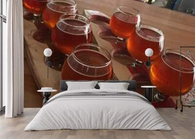 Flight of beer in small glasses with surfboard try. Wall mural