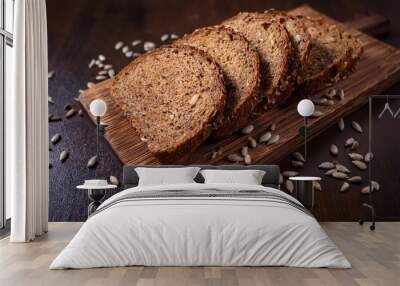 Slices of barley bread on a wooden board Wall mural