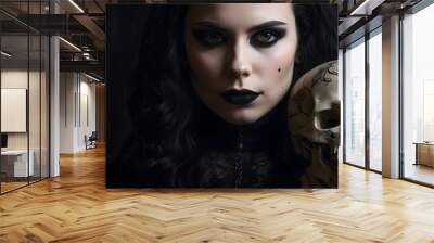 A goth woman holding a human skull. Wall mural