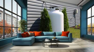 A large propane tank on the side of a house Wall mural