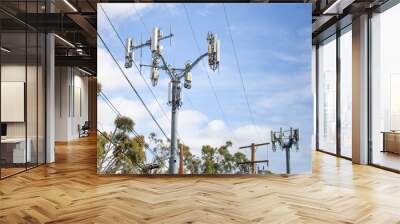 A modern cell tower with a cloudy sky background Wall mural