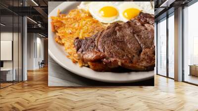 A view of a breakfast plate of steak and eggs. Wall mural